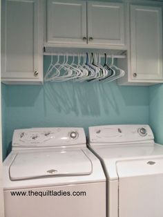 a white washer and dryer sitting next to each other in a laundry room