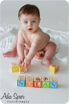 a baby is playing with blocks on the floor