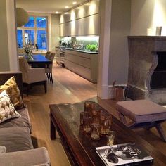 a living room filled with furniture and a fire place in the middle of a room