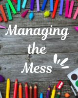 the words managing the mess surrounded by colored crayons and pencils on a wooden surface