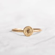 This gorgeous Solid 14K custom initial ring, is engraved with dainty handmade floral decoration. A special gift ring to cherish for many years to come, the top gold disk is engraved with a single letter but you choose to engrave any other word in the following link: https://etsy.me/2HCG2W2 A perfect gift idea for your graduation or birthday gift. Band width: 1.2 mm / 0.05' Inch, band thickness: 0.8 mm / 0.03' Inch Top ring diameter 6 mm / 0.24' Inch *Each extra letter cost $2 - Please add the at Wreath Crown, Custom Wedding Band, Engraved Initials, Top Rings, Floral Ring, Single Letter, Initial Ring, Floral Decoration, Custom Initials