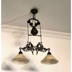 an old fashioned chandelier with three lights hanging from it's ceiling fixture