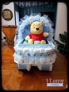 a winnie the pooh diaper cake sitting on top of a table in front of a doorway