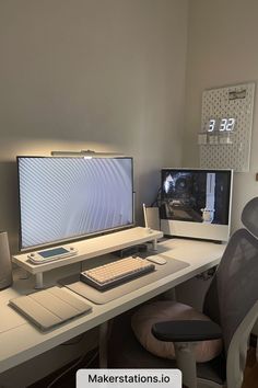 there is a desk with two monitors and a keyboard on it in front of the monitor