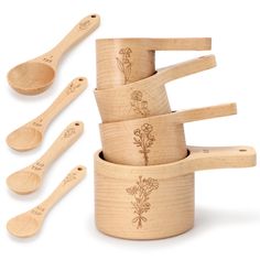 wooden measuring cups and spoons with flowers engraved on them