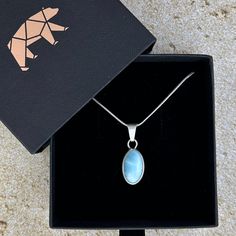 The most beautiful gemstone found only in the Dominican Republic, Larimar is a stone of coolness and calm, much like the native waters it resembles. Larimar is a powerful healer! It can help with panic attacks, anger, fear and other stress-related issues. Secure this unique and beautiful one-of-a-kind incredible Larimar pendant around your neck and breathe in the calm of the Caribbean ocean! AA Grade Double-sided! Includes an 18” sterling silver chain Lead-free; nickel-safe Set in 925 sterling silver Pendant is approximately 1.2”H (31mm) x .45”W (11.6mm) Comes in our exclusive luxury gift box Source: Dominican Republic Any visible imperfections and/or cracks are due to natural formation Product color may slightly vary due to photographic lighting sources! Disclaimer: Crystals should not be Caribbean Ocean, Orange Stone, Larimar Pendant, Book Jewelry, The Dominican Republic, Clear Stone, Purple Stones, Luxury Gift Box, Stirling