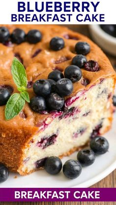 blueberry breakfast cake on a white plate with fresh blueberries in the background and text overlay