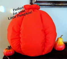 a stuffed pumpkin sitting on top of a table