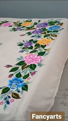 an image of a table cloth with flowers on it and the name fancy arts printed on it