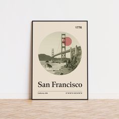 the san francisco poster is displayed in front of a white wall with a wooden floor