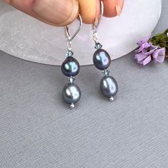 ✦This unique and beautiful pearl necklace and earring set makes a perfect anniversary gift for the wife, or as a gift for mom. ✦Rice-shaped peacock bluish-purple freshwater pearls, 7mm width by 8mm in length, are strung on sturdy beading wire with iridescent blue bicone crystal beads separating each pearl.     ✦Necklace length is approximately 16.5" long with a 2" inch length adjustment, for a maximum length of 18.5 inches.  Closes with a small sterling silver lobster clasp. ✦Matching earrings have 2 pearls, separated by bicone crystals wire wrapped and hung from sterling silver leverback ear wires. ✦Purchase options are earrings only, necklace only, or necklace and earring set. Please select at check out. ✦Your jewelry will be packaged in a beautiful and reusable organza bag. All items wi Crystal Beaded Necklace, Black Pearl Earrings, Bluish Purple, Beautiful Pearl Necklace, Diy Jewelry Projects, Blue Peacock, Iridescent Blue, Crystal Bead Necklace, Handmade Jewelry Gift