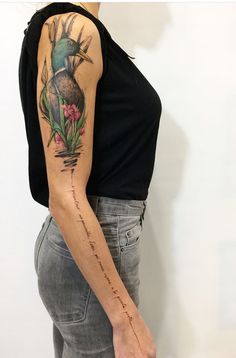 a woman with a bird tattoo on her arm