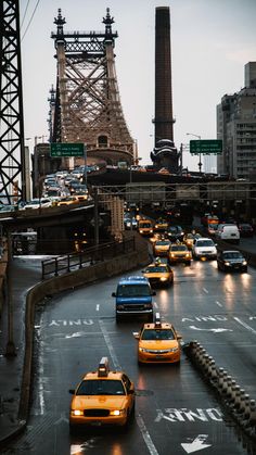 cars are driving down the street in front of the eiffel tower and bridge