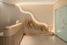 a bathroom with a glass door and some plants on the wall