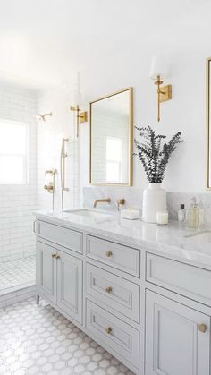 a white bathroom with two sinks and mirrors