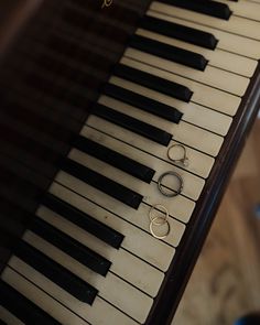 two pairs of rings sitting on top of an old piano