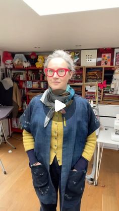 a woman with glasses and a bow tie is standing in a room full of books