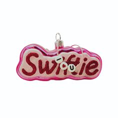 an ornament with the word swiffie in red and pink glitters