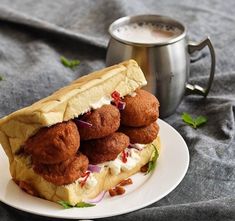 a sandwich on a plate with some meatballs in it