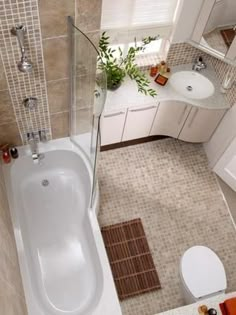 an aerial view of a bathroom with a bathtub, toilet and sink in it