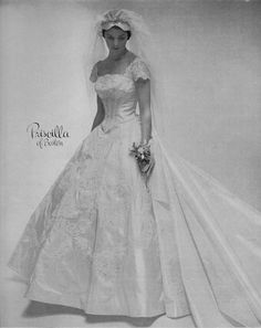 a black and white photo of a woman in a wedding dress