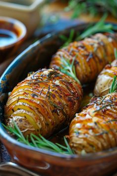 Hasselback potatoes seasoned with herbs and drizzled with sauce. How To Make Hasselback Potatoes, Sweet Potato Hasselback Recipes, Rosemary Scalloped Potatoes, Easy Fancy Potatoes, Fancy Baked Potatoes, Christmas Dinner Starters Ideas, Rosemary Potatoes Roasted, Fancy Potatoes Side Dishes, Hassle Back Potatoes