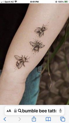 two bees tattoo on the left forearm and right arm, one is black with white dots