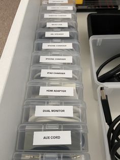 several plastic containers with labels on them are lined up next to each other in a drawer