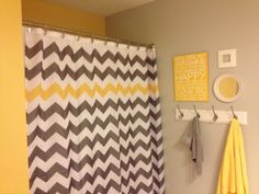 the bathroom is decorated in yellow and gray