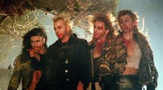 the group of men are dressed up in leathers and leopard print clothes, posing for a photo