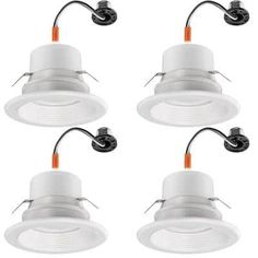 four white downlights with wires attached to the ceiling and one light on each side