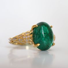 Read about our payment plans before proceeding.This is what dreams are made of. This emerald ring features an insanely gorgeous deep green natural cabochon emerald stone, embellished with 57 natural white diamonds with details like phoenix wings. A classy and sleek ring to treasure forever. Handcrafted in your choice of 14K yellow gold, rose gold, and white gold. The emerald shown is the exact same emerald you will receive. 14K solid gold Natural 12*9mm natural cabochon emerald. Approx. 2.8ct~. Luxury Oval Emerald Birthstone Ring, Yellow Gold Emerald Ring With Oval Cabochon, Yellow Gold Emerald Ring Oval Cabochon, Fine Jewelry Emerald Oval Cabochon Ring, Fine Jewelry Emerald Ring With Oval Cabochon, Emerald Oval Cabochon Ring As A Gift, Fine Jewelry Emerald Green Oval Cabochon Ring, Luxury Emerald Ring With Oval Cabochon, Exquisite Oval Green Emerald Ring