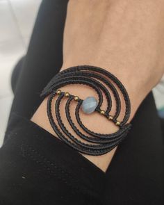 a close up of a person's wrist wearing a bracelet with beads on it