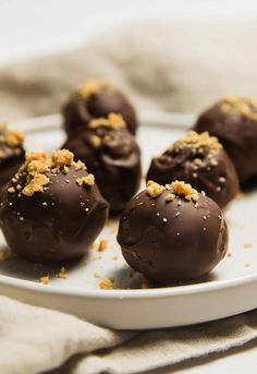 chocolate covered candies on a plate with sprinkles and crumbs