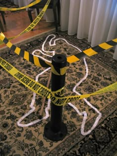 caution tape is taped around a pole on the floor