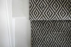 two black and white rugs hanging on the wall