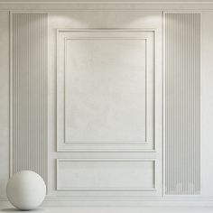 an empty room with white walls and a ball on the floor in front of it