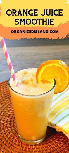 an orange juice smoothie in a glass with a striped straw next to it on a woven place mat