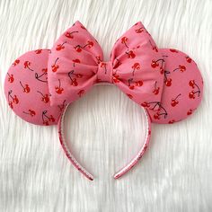 a pink minnie mouse ears with cherries on it