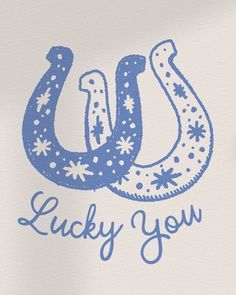 a t - shirt with the words lucky you printed on it, and a horseshoe