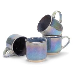 three mugs are stacked on top of each other, one is blue and the other is silver