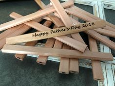 a pile of wooden clothes pins with the words happy father's day on them