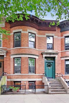 an apartment building with stairs leading up to the front door