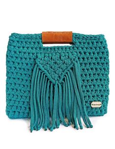 a blue crocheted purse with fringes on it