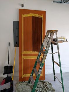 a ladder leaning against an orange door in a room