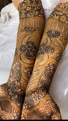 the legs and feet of a woman with henna tattoos