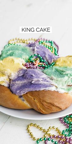 a white plate topped with a cake covered in mardi gras