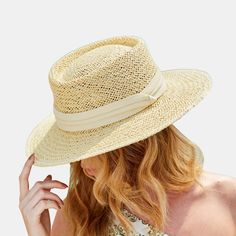 Step into summer style with this timeless straw boater hat. Expertly woven from lightweight and breathable straw material, it offers a perfect blend of fashion and function. The classic boater silhouette exudes an effortless elegance, while the natural straw hue adds a touch of warmth and sophistication to any ensemble. Whether you're lounging by the pool, strolling through a garden, or exploring a charming seaside town, this hat will be your chic companion, providing both sun protection and a s Classic Solid Color Sun Hat For Beach, Classic Beach Sun Hat, Casual Paper Straw Boater Hat, Classic Summer Sun Hat With Visor, Spring Coastal Boater Hat Made Of Toquilla Straw, Casual Toquilla Straw Boater Hat For Warm Weather, Casual Woven Toquilla Straw Boater Hat, Solid Fedora Straw Hat With Uv Protection, Solid Color Fedora Straw Hat With Uv Protection