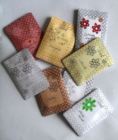 six small pieces of fabric with flowers and polka dots on them, all in different colors