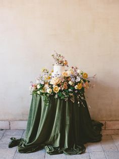 a cake on top of a table covered in green cloth